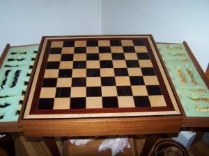 Ebony and Curly Maple chess board with matching chess pieces. trimmed in bloodwood.