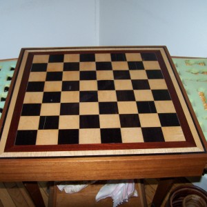 Ebony and Curly Maple chess board with matching chess pieces. trimmed in bloodwood.