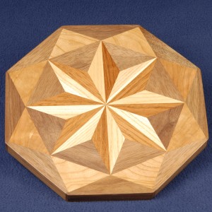 Pin wheels are a favorite. This ash and Brazilian cherry is framed with triangles of walnut and cherry.