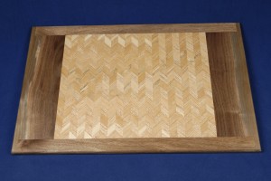 The lighter shades of cherry and oak blend together in less contrast highlighting the grain of this tray.