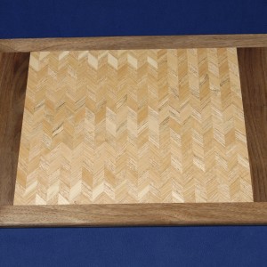 The lighter shades of cherry and oak blend together in less contrast highlighting the grain of this tray.