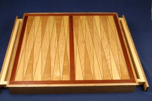 This 24 by 24 inch backgammon board is easier than it looks. Includes drawers.