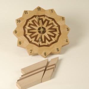 A simple 3 generation pattern of walnut and maple formed into a circle to create this wall clock.