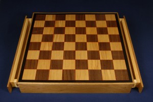 Another chess board of birch and walnut with red veneer highlights and ebony trim. Includes drawers.