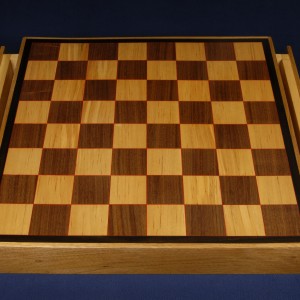 Another chess board of birch and walnut with red veneer highlights and ebony trim. Includes drawers.