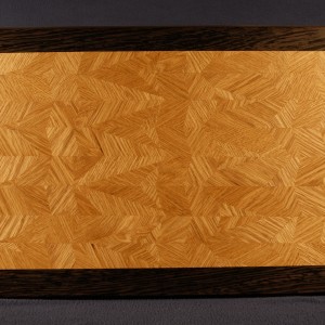 This multi generation 45/60A60AD is of white oak, with a wenge boarder. The piece accents the grain and needs on contrast in color to show off the intricate designs and patterns. A spline was used to affix the boarder.