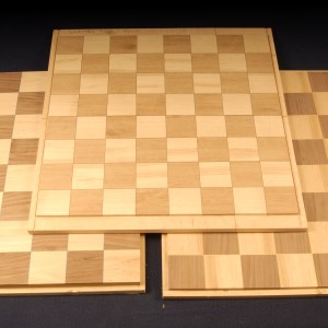 Chess blanks of ash, walnut and mahogany are mounted to a substrate and ready for application in your project.