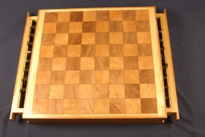 Chess board with walnut and cherry and a black veneer highlight which is accented by an ash trim.